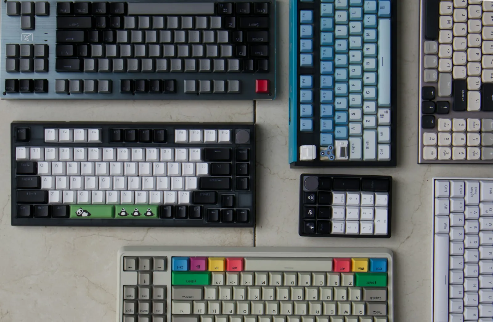 Several mechanical keyboards laid out together on a table